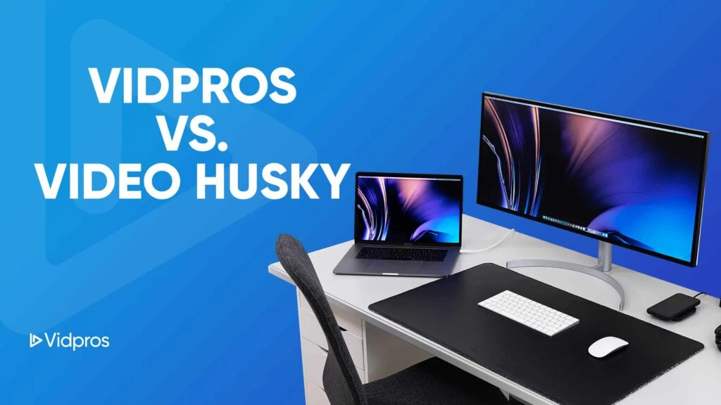 A modern desk setup with a laptop and large monitor displays vibrant screen savers. Text on a blue background reads Vidpros vs. Video Husky. Geared for content creators seeking unlimited video solutions, the desk features a keyboard, mouse, and black chair nearby.