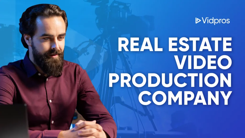 A bearded man in a red shirt sits at a table with a laptop, smiling. Behind him, the text reads Real Estate Video Production Company, emphasizing the focus on expert video services for realtors. A logo says Vidpros, with video cameras and equipment creating a blurred backdrop.