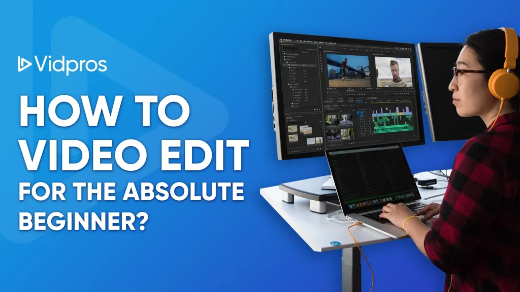 A person wearing headphones is immersed in video editing, using software on a laptop with dual monitors at a desk. Text reads: Vidpros: How to Video Edit for the Absolute Beginner? The serene blue background complements the scene perfectly.