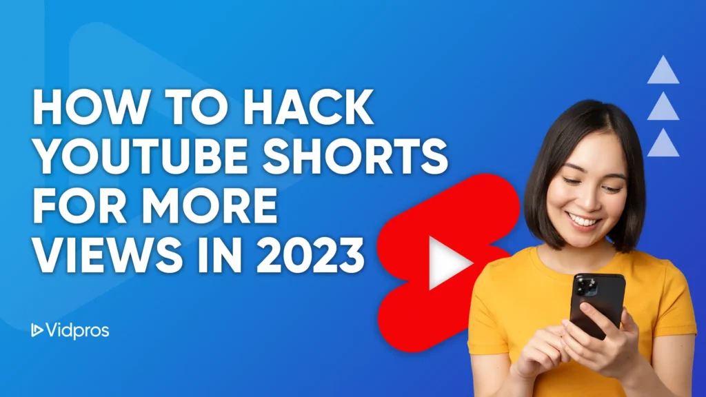 A smiling person in a yellow shirt uses a smartphone, with text reading How to Hack YouTube Shorts Algorithm for More Views in 2023 against a blue background. A red play button icon appears behind them. The Vidpros logo decorates the bottom left corner.