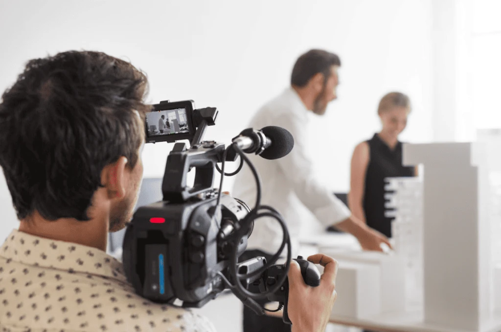 alt="videographer filming a couple demonstrating how to plan for video content online"